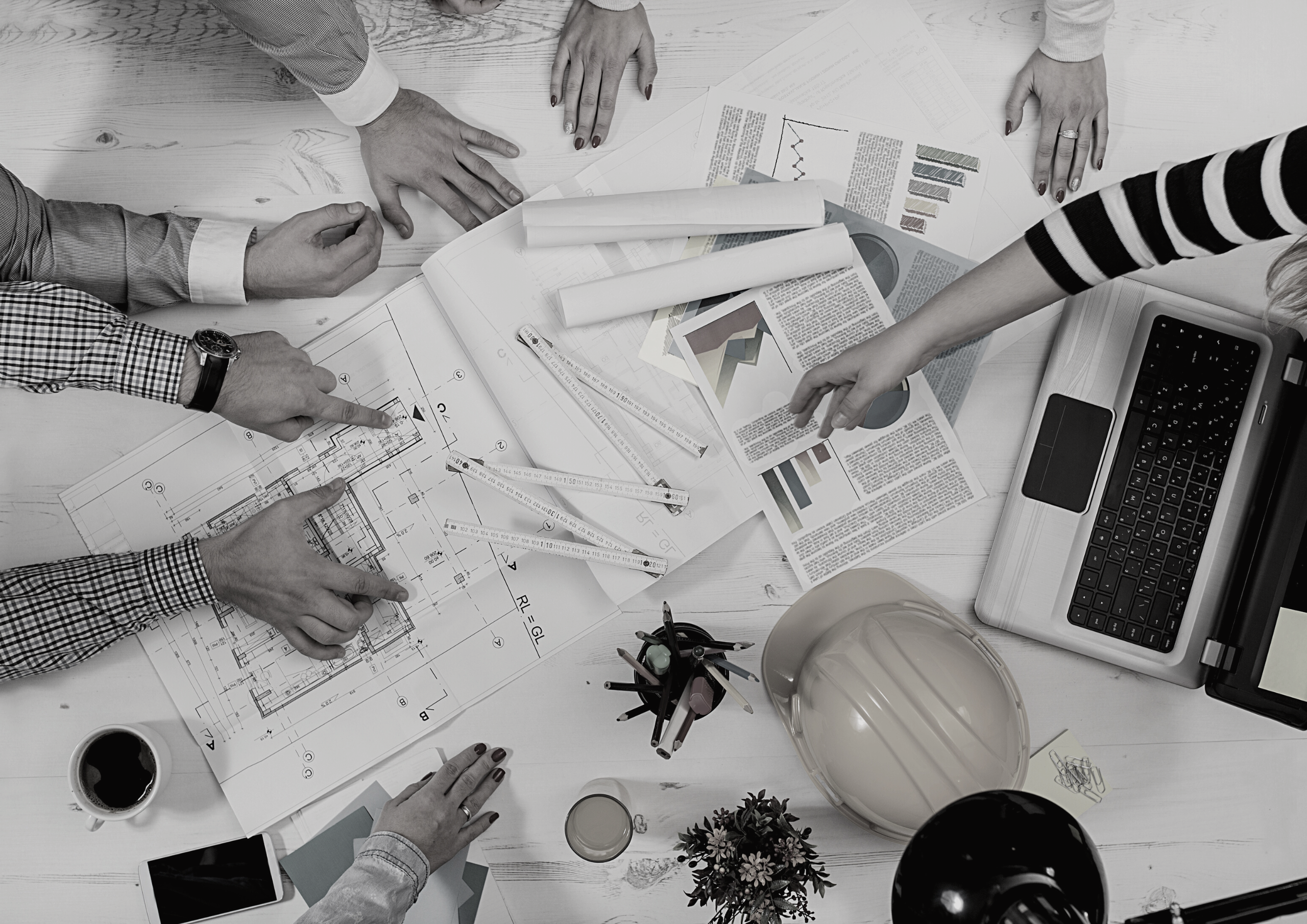 Project Manager image of team around plans