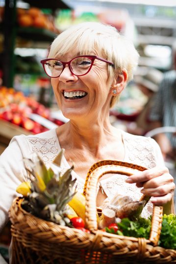 Senior woman buying vegetables at farmers market